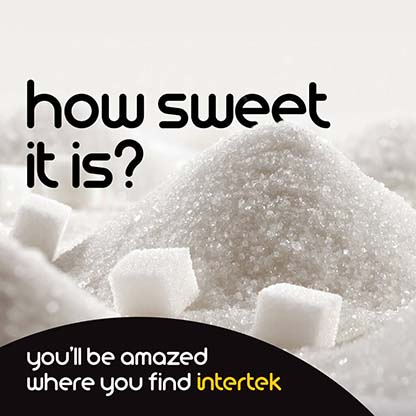 Sugar cubes next to grains of white sugar