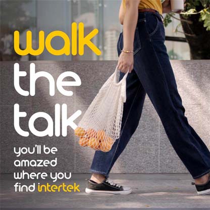 A woman walking with a reusable grocery bag